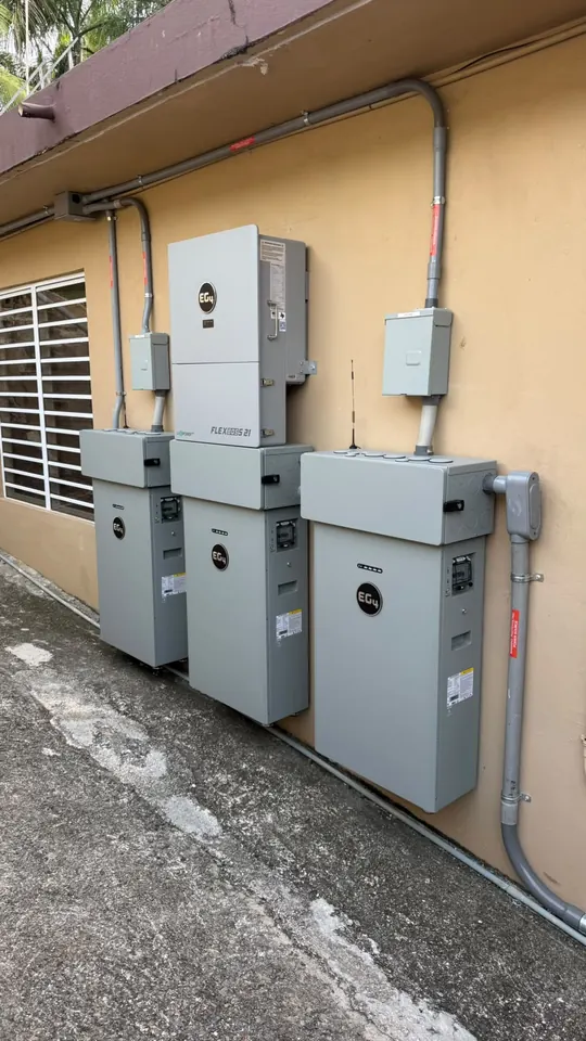EG4 FlexBOSS21 inverter with three EG4 batteries installed on the exterior wall of a home in Puerto Rico